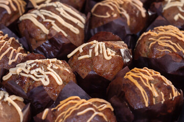 Cupcakes with white chocolate on top, selective focus on the center of the image.