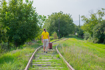 aged man in a yellow t-shirt runs on the rails