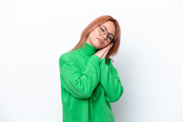 Young Russian girl isolated on white background making sleep gesture in dorable expression