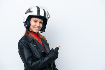 Young Russian girl with a motorcycle helmet isolated on white background pointing back