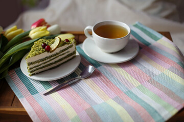 Romantic breakfast in bed on the occasion of International Women's Day. A bouquet of tulips for congratulations on March 8. Spring set for a good mood.