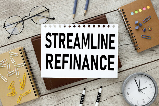 streamline refinance. text on a piece of paper on a brown notepad on a wooden background