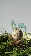 cheerful easter bunny sticking out its head from green grass easter nest isolated