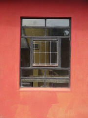 Fototapeta na wymiar old window on faded red wall