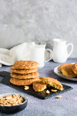Fresh peanut cookies on a slate and in a plate on the table. Homemade pastries. Vertical view. Copy space
