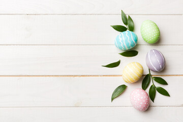 Colorful Easter eggs with spring flower leaf isolated over white background. Colored Egg Holiday border