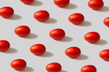 Pattern of red eggs on a gray background. The concept of minimal food.Easter