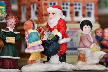 Santa Claus and a Child in a Christmas Village Scene
