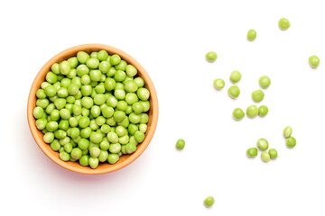 Green peas in a ceramic plate on a white background