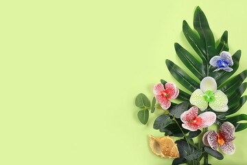 Summer composition, exotic abstract background with tropical palm leaves and orchids on sunny...