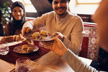 Fototapeta na wymiar Close-up of Muslim people eat baklava for dessert at home.