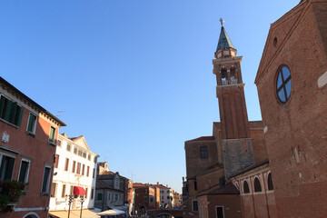 Fototapeta na wymiar View of town Chioggia with church steeple of Chiesa della Santissima Trinita in Veneto, Italy