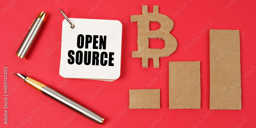 Poster On a red surface lie the bitcoin symbol, a pen and a notepad with the inscription - Open Source
