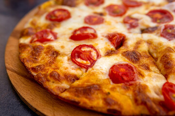 pizza margherita on a wooden plate close-up