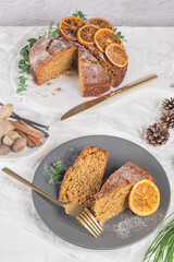 Christmas orange and spice cake. Decorated with dried oranges on kitchen countertop