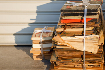 Antique book bundles on the street in sun