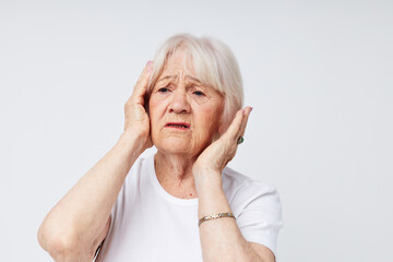 elderly woman holding his head discontent problem cropped view