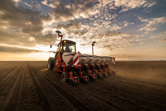 Farmer with tractor seeding