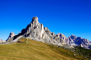 Fototapeta na wymiar Scenic landscape of Giau Pass or Passo di Giau - 2236m. Mountain pass in the province of Belluno in Italy, Europe. Italian alpine landscape. Travel icon of the Dolomites
