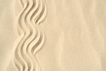 Fototapeta na wymiar Texture of sea sand background closeup with ornament