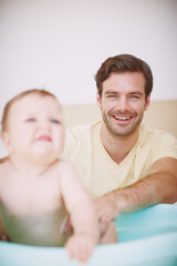 Sometimes she doesnt like bathtime that much.... A young father bonding with his baby daughter at bathtime.