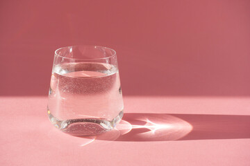 Glass of fresh pure water. Hard light, deep shadow.