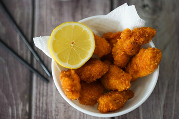 Crispy Fried Chicken Garnished with Lemon