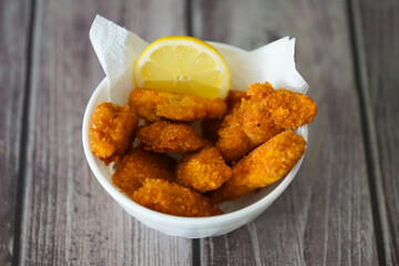 Crispy Fried Chicken Garnished with Lemon