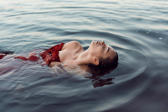 Blonde Girl Bathes In A Summer Lake