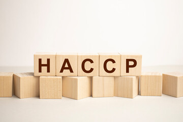 HACCP word from wooden blocks on white desk