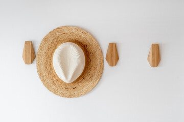 Sun hat on hanger for clothes in hall