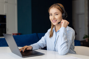 Cheerful woman with headset and laptop working from home