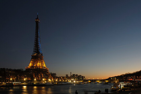 Paris, France - February 26th, 2022 : Eiffel Tower with the color of Ukraine flag