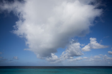 Naklejka na ściany i meble Turquoise sea, blue sky with big cloud. Seascape.