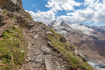 High mountain path with peaks of Palla Bianca and its glaciers in the background, Vallelunga, Alto Adige - Sudtirol, Italy. Popular mountaineering destinations
