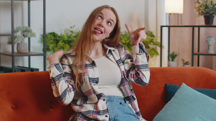 Funny amusing young funny woman in shirt looking awkward making playful silly facial expressions...