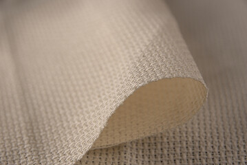 Beige cloth with a clear texture and warm colors of chiaroscuro for the background.