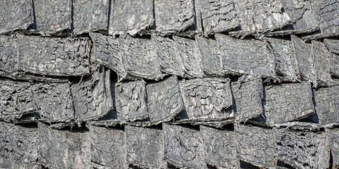 Wooden aged tile on the roof of the house, natural surface texture background