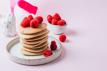 Pancakes made with protein powder. Healthy summer breakfast gluten free with protein and raspberries