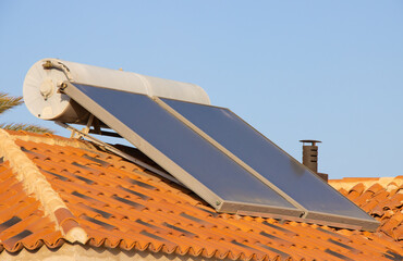 solar water panels on red tile roof