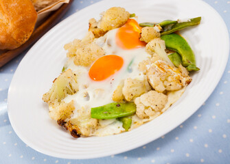 Appetizing cauliflower fried eggs for breakfast. High quality photo
