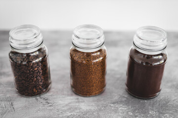 jars of coffee beans next to jar of instant coffee, best tasting option and coffee culture