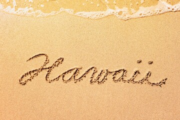 Fototapeta na wymiar Hawaii inscription on the sand. Summer Hawaii beach vacation background 