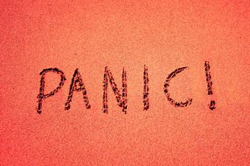 Fototapeta na wymiar Panic word written on sand isolated in red color. 