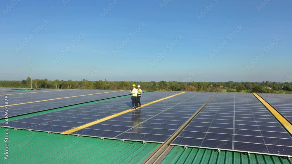 Wall mural professional engineer using drone and digital tablet maintaining solar cell panels together on build