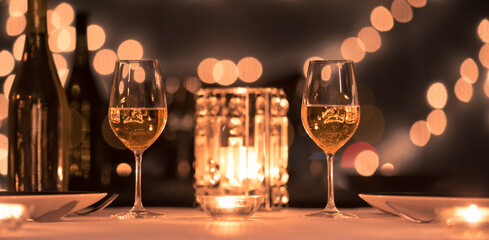 Wine glasses in a fine dinning restaurant candle light dinner romantic setting 