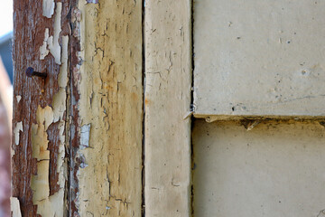old wooden weatherboard wall with peeling paint
