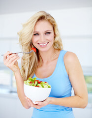 The right kind of diet. Portrait of a gorgeous young woman eating a healthy salad.