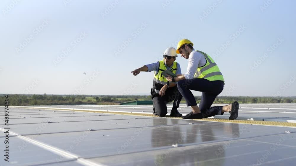 Wall mural professional engineer using drone and digital tablet maintaining solar cell panels together on build