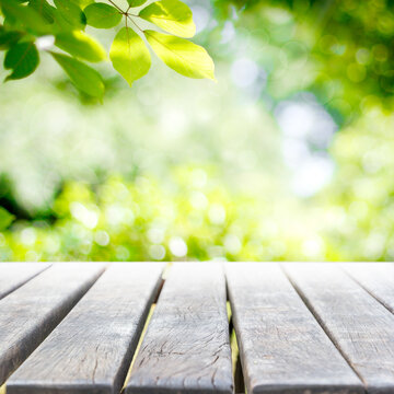 Empty wooden table with garden bokeh background with a country outdoor theme,Template mock up for display of product